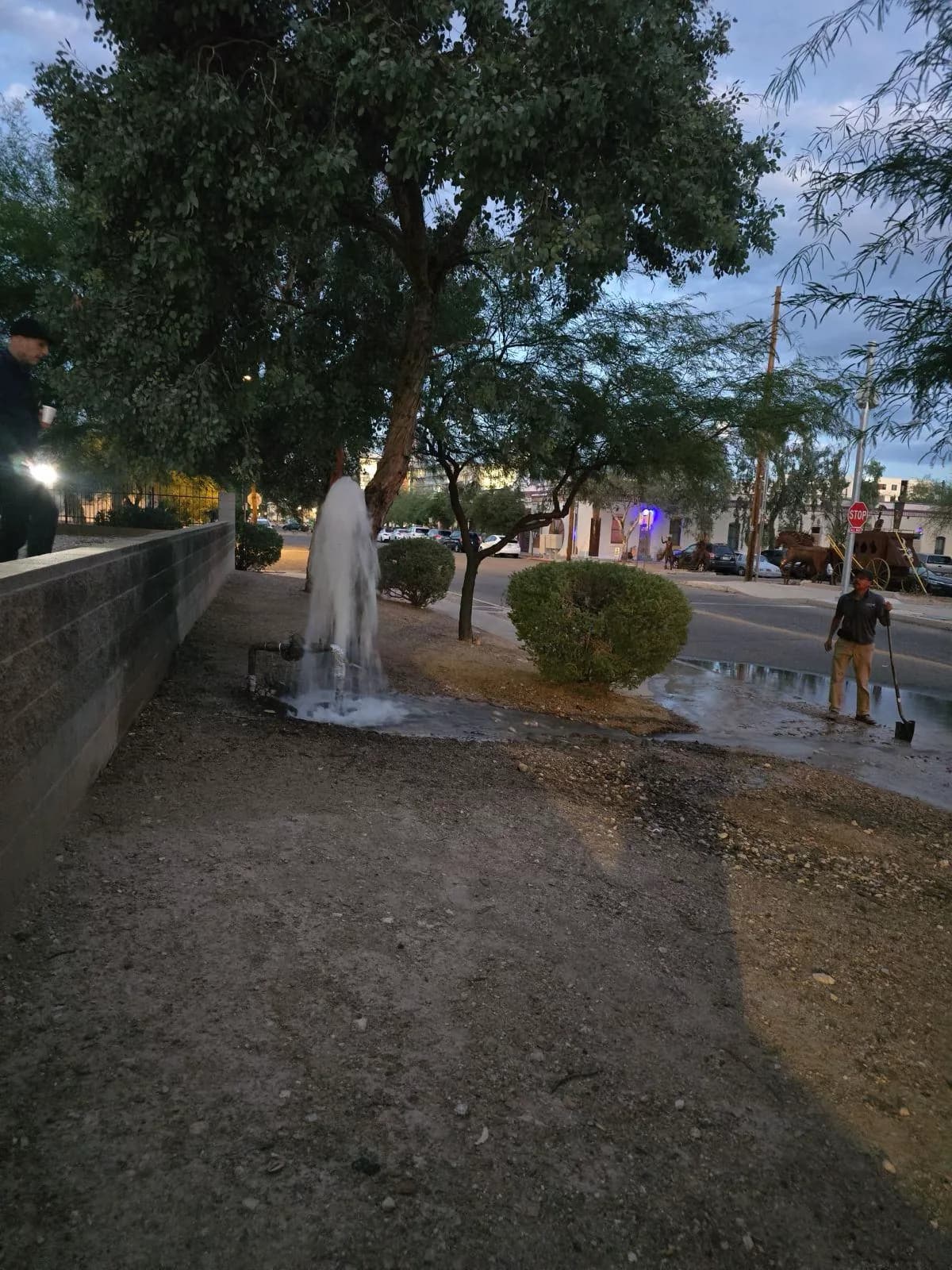 Burst water main flooding a downtown Tucson street at night