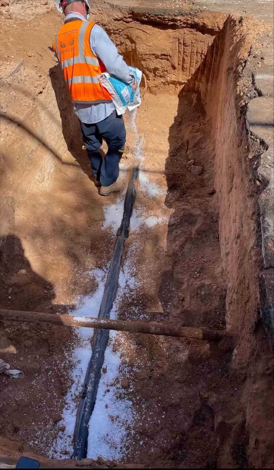 Trenched drain replacement with protective bedding in Tucson caliche soil