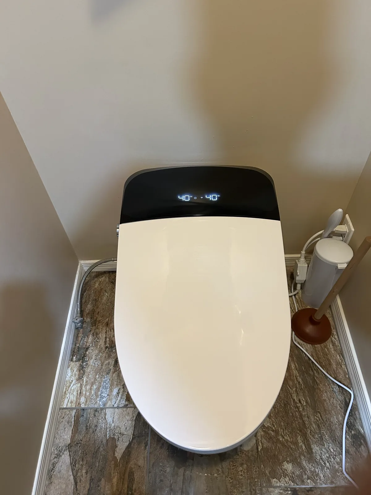 Completed wall-hung smart toilet installation with heated seat controls